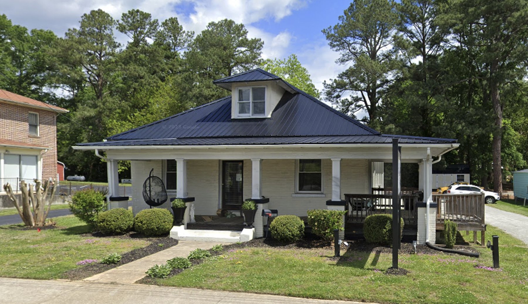 The Picasso's Salon house on East Atlantic Street in South Hill, Virginia, with a wide covered front porch